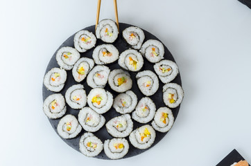 Maki sushi, rolls on slate plate.