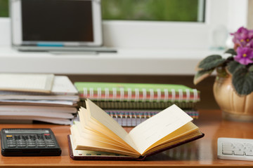 Office desk table with computer, supplies, flower. Copy space for text