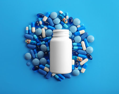 Heap of pills on blue background