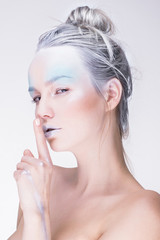 Naklejka premium Model in creative image with silver blue artistic make-up