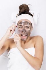 Portrait of a woman at the spa, screaming during the removing the mask from the face