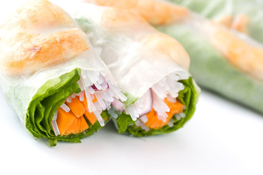 Vietnamese rolls with vegetables, rice noodles and prawns isolated on white background

