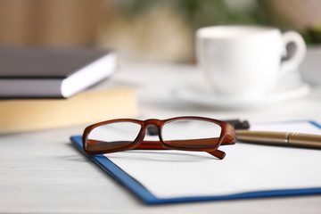 Close up view of glasses on clipboard. Healthy eyes concept