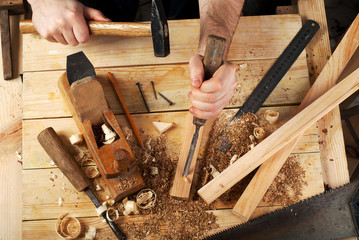 Carpenter tools on wood table background. Top view. Copy space