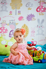 The baby playing with toys  in room