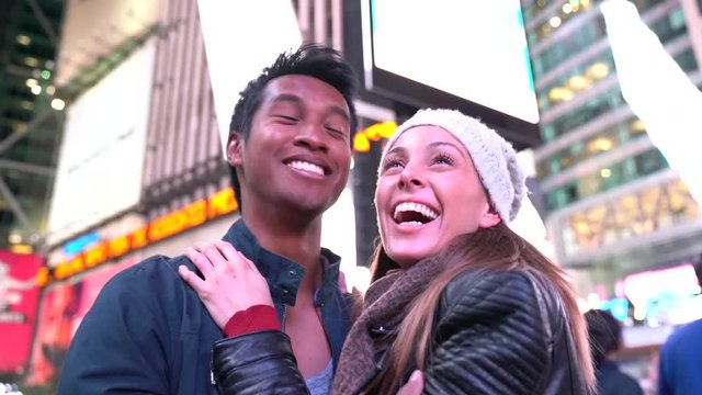 Couple at Times Square laughing outloud