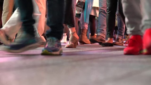 Closeup of people's feet walking at night