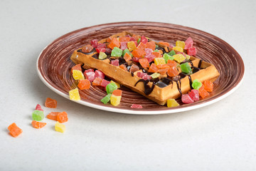 Plate of belgian waffles with cream, candied and chocolate