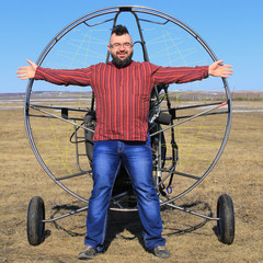 portrait of a man against the backdrop of a motor glider