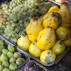 grapes, quince, tangerines, figs in containers for sale in a vegetable shop in Tbilisi