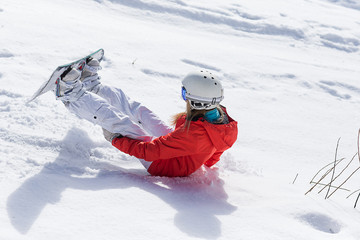 Ssnowboarder on slopes in the sunny morning