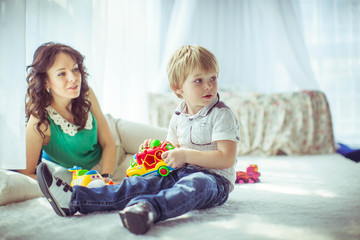 little cute boy and his mother playing together