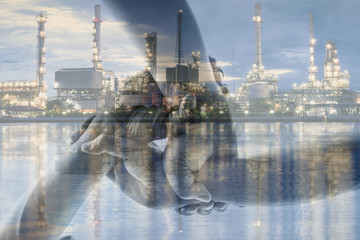 Double exposure of three hand collaboration of teamwork and
 Oil refinery At sunset for business...