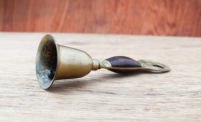 Ancient bronze bell on wood background