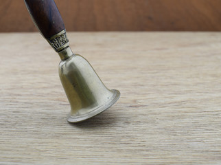 Ancient bronze bell on wood background
