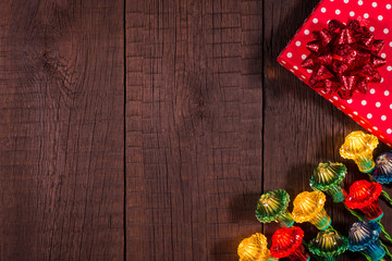 Christmas gifts boxes with garland on a wooden background.