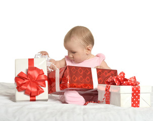 Baby girl sitting  with gifts