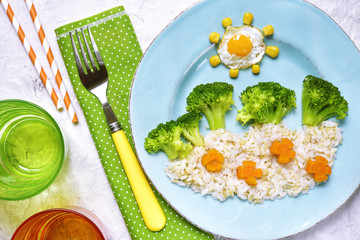 Kids breakfast with brown and white rice,fried egg and vegetable © lilechka75