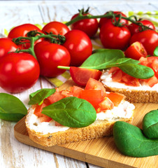 Bruschetta with spinach and cherry tomatoes on toasted baguette