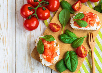 Bruschetta with spinach and cherry tomatoes on toasted baguette