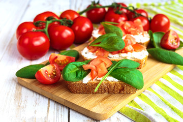 Bruschetta with spinach and cherry tomatoes on toasted baguette