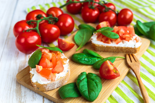Bruschetta with spinach and cherry tomatoes on toasted baguette