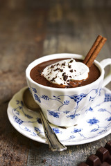 Hot chocolate with whipped cream in a vintage cup.