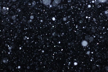 Real falling snow on a black background for use as a texture layer in your project. Add as 