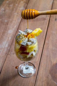 Fruit salad with honny on whites background