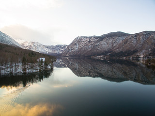 Fototapeta premium Aerial: Beautiful Bohinj Lake At Winter With Mountain Background