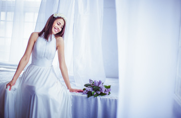 The tenderness bride sits near bouquet