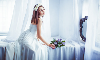 The tenderness bride sits near bouquet