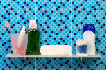 Women's hygiene products on shelf in bathroom, background.