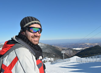 Fototapeta na wymiar Handsome young man in the ski resort