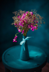 beautiful bouquet of purple flowers in a blue vase