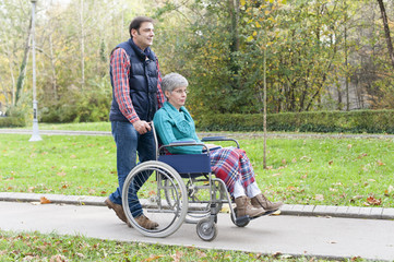 Son with Mother in wheel chair at the park 