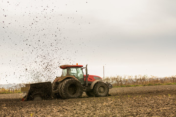 Obraz premium Tractor with double wheeled ditcher digging drainage canal