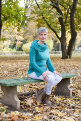 Middle aged woman in the autumn park