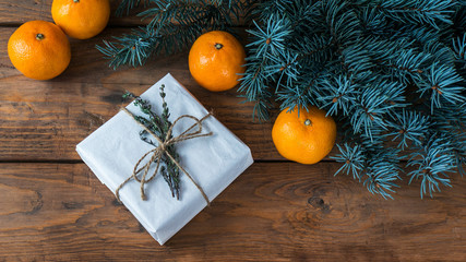 Christmas background with fir branches on wooden board, vintage style