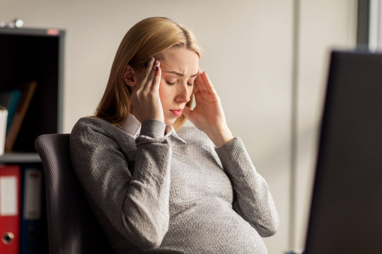 Pregnant Businesswoman Feeling Sick At Office Work