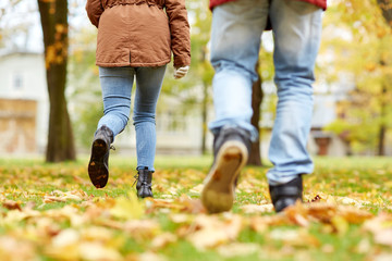 young couple running in autumn park