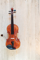 Naklejka na ściany i meble Wooden Classic Violin on a Weathered Wooden Background