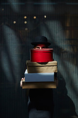 Girl behind gift boxes