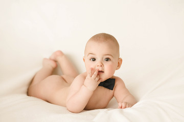 Incredible and charming newborn baby lying on a white background