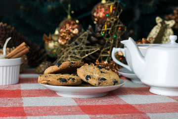 Obraz na płótnie Canvas Cookies with chocolate crumbs on ornament napkin against blurred background, close up