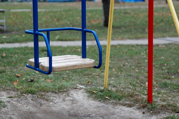 Children's swing blue color in the park.
