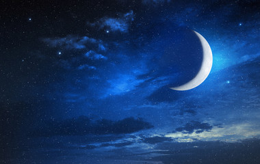 Obraz na płótnie Canvas moon in a starry and cloudy sky