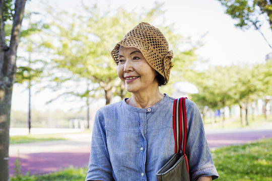 Portrait of a smiling senior woman wearing a crochet hat.