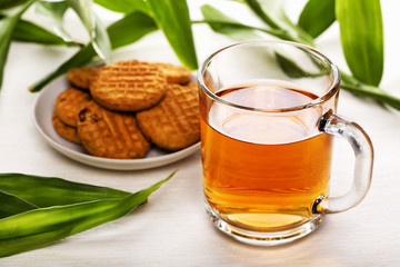 Cup of black tea and biscuits on a plate