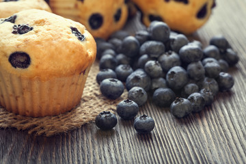muffin with blueberries on a wooden table. fresh berries and swe